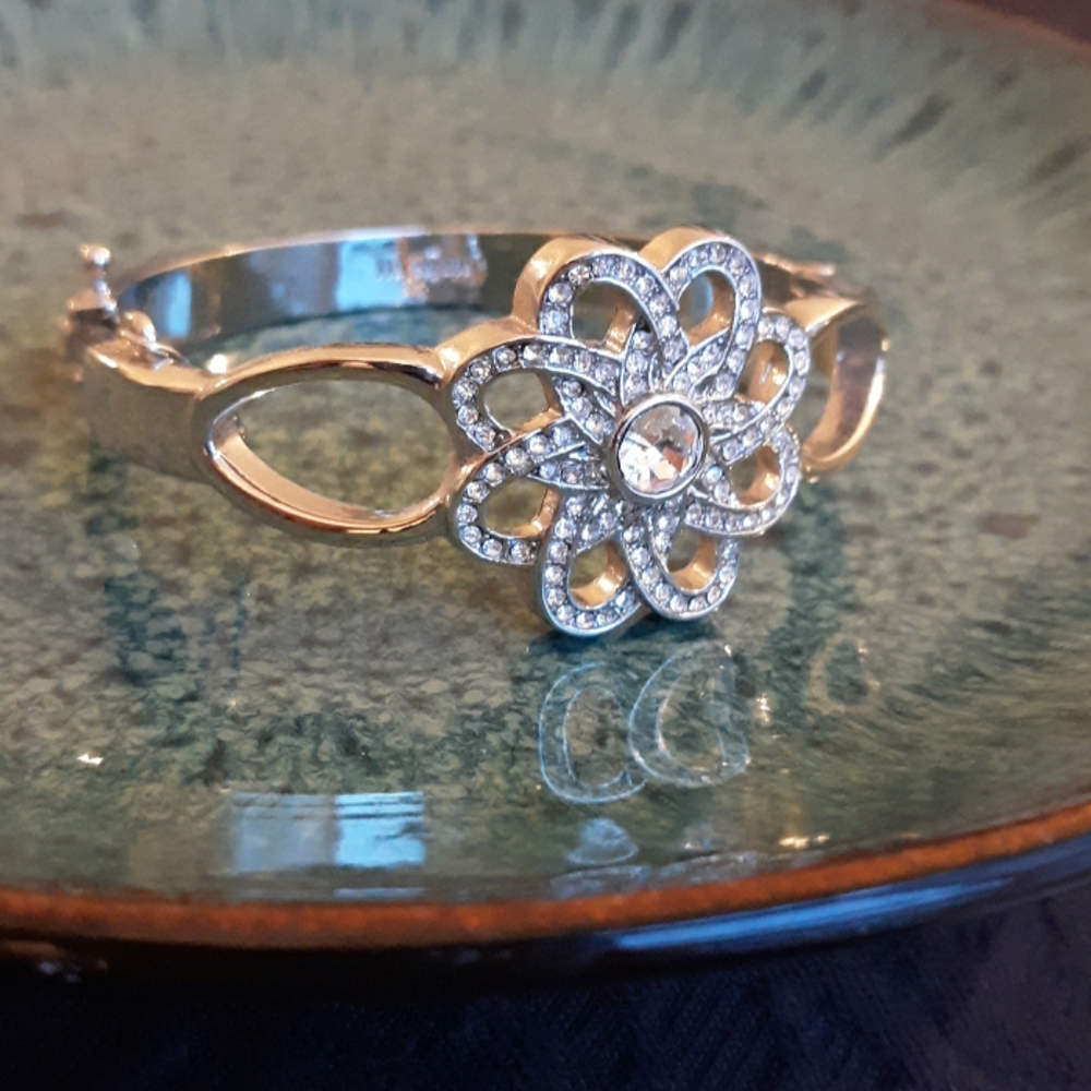 Silver clasp bracelet with jeweled flower